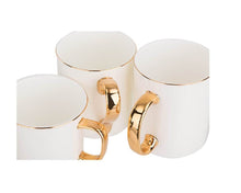 Cargar imagen en el visor de la galería, Taza blanca de porcelana con borde y asa dorado Sublimarts
